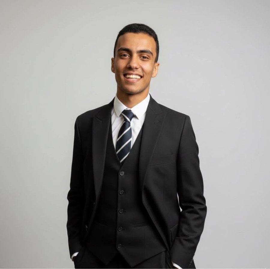 Sherif Abdelkarim in a dark three-piece suit